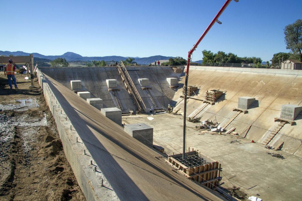 5 Reservoirs Retrofit Program - concrete being piped into project