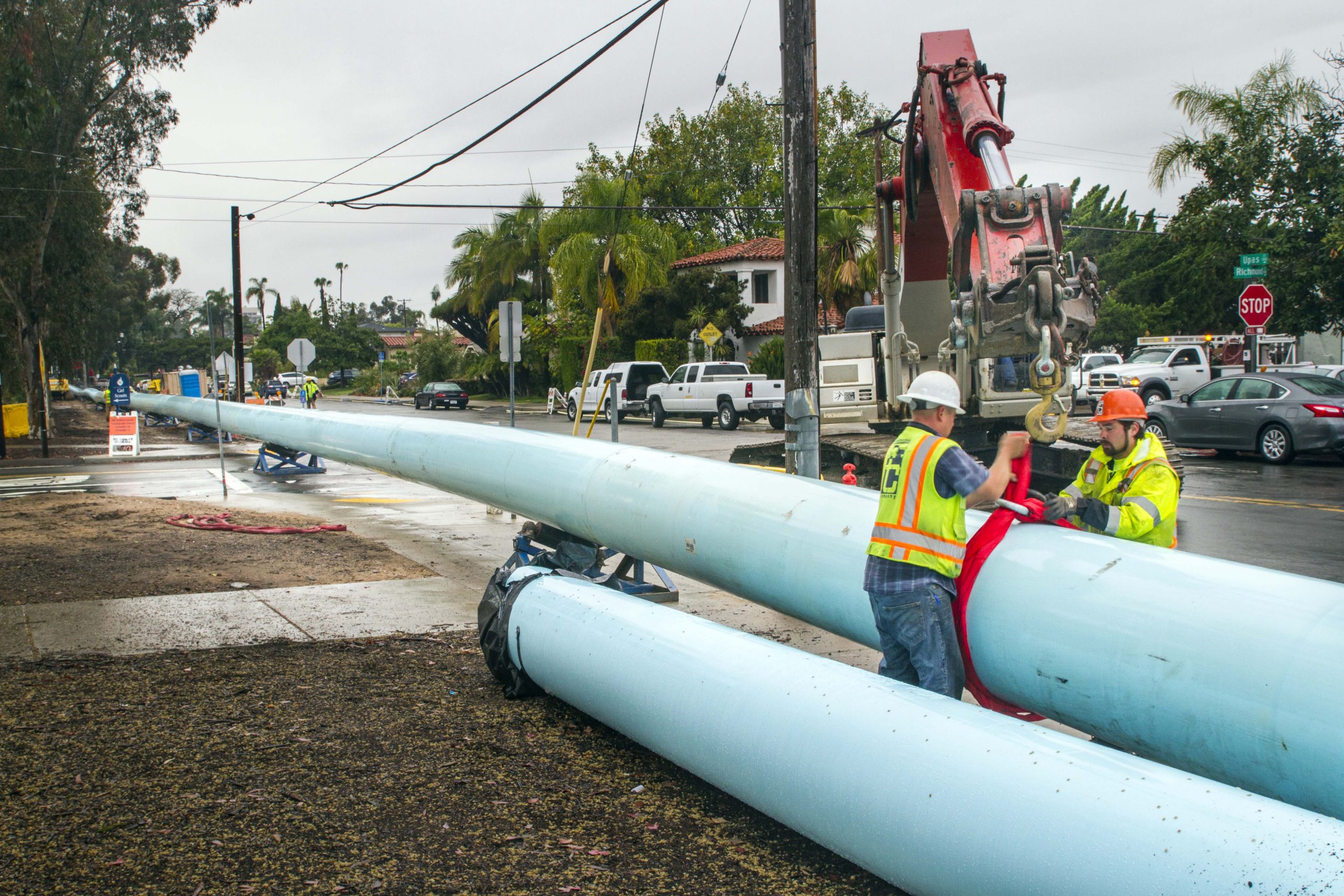 Upas Street Pipeline - Men working to position large pipes