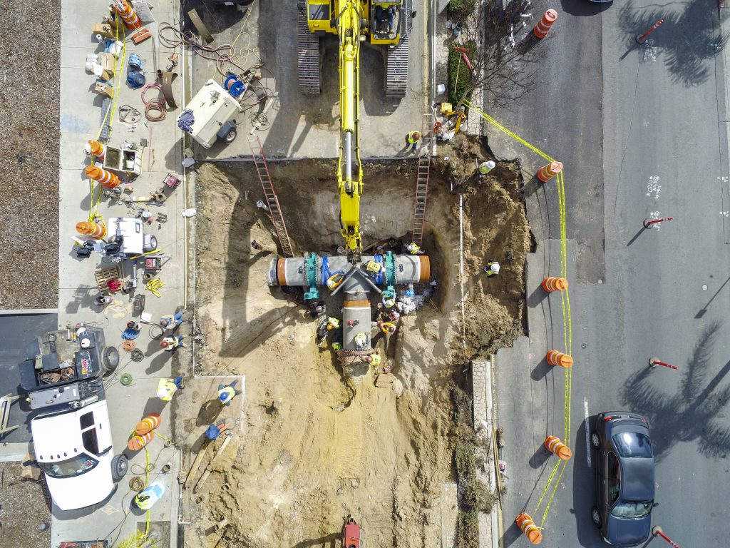 Mid-City Pipeline Phase 2-A overhead view of workers placing pipe