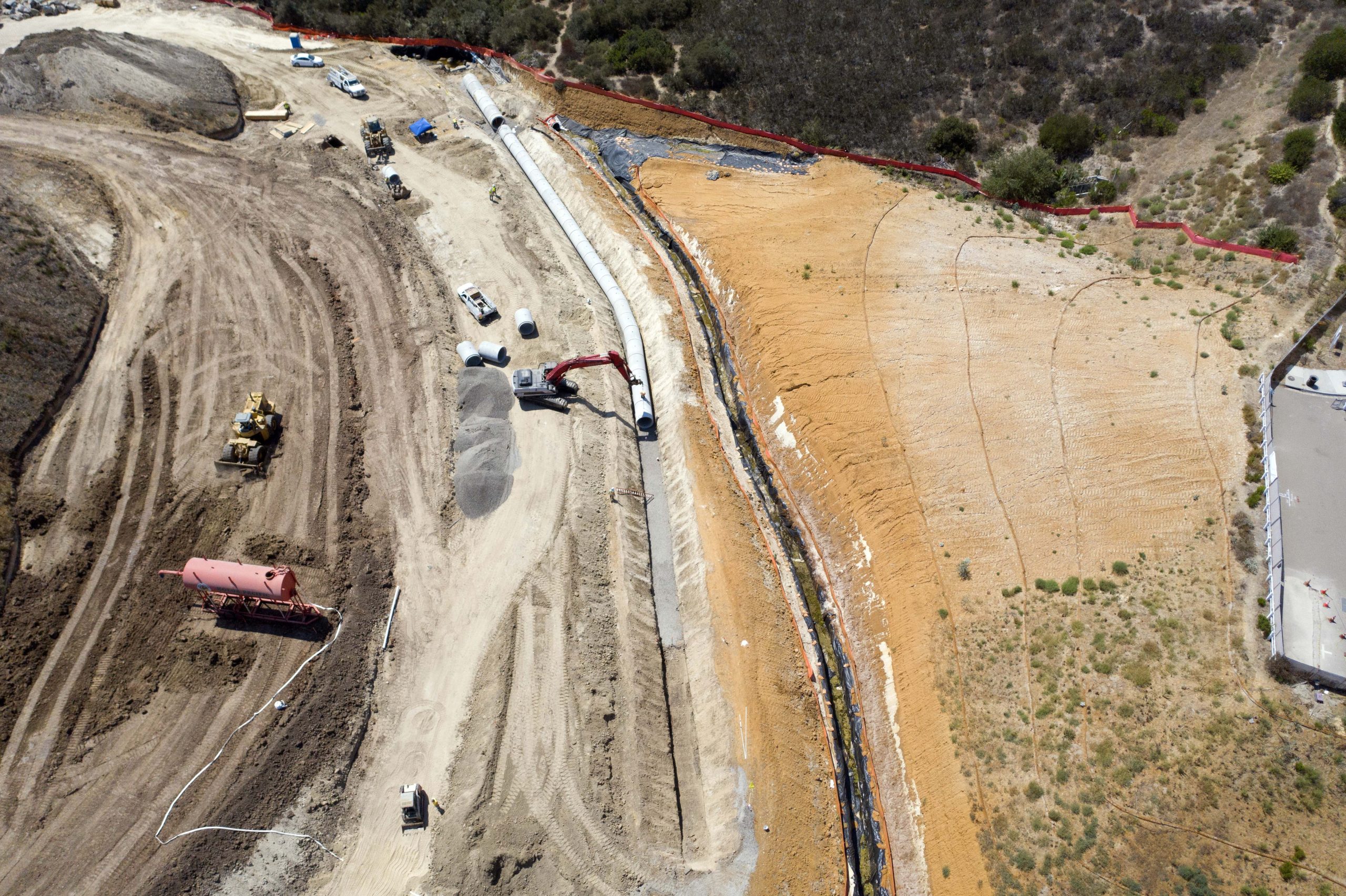 Merge 56 overhead view of pipes being laid in trench