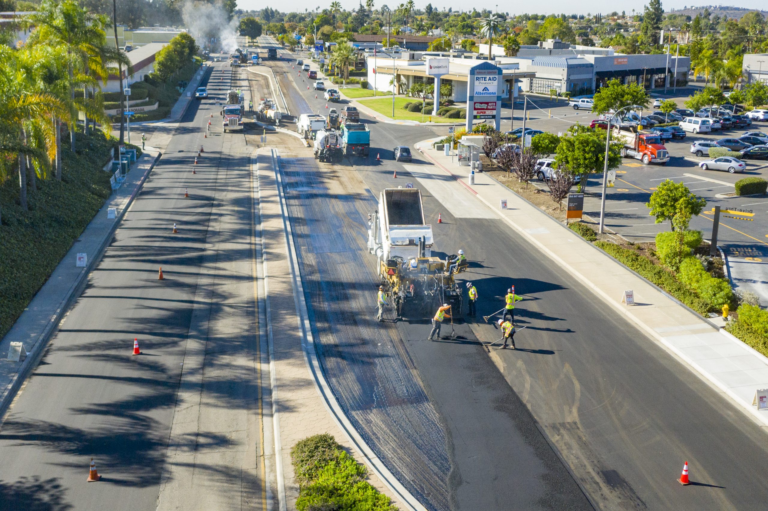 Navajo Pump Station paving crew laying asphalt on busy street