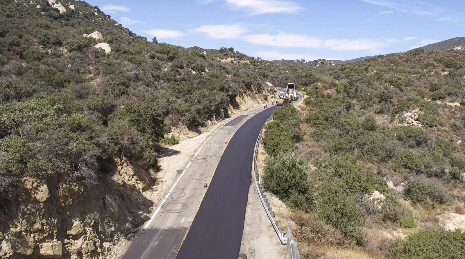 18604 County Overlay Road Maintenance, view of paving crew laying asphalt on windy mountain road