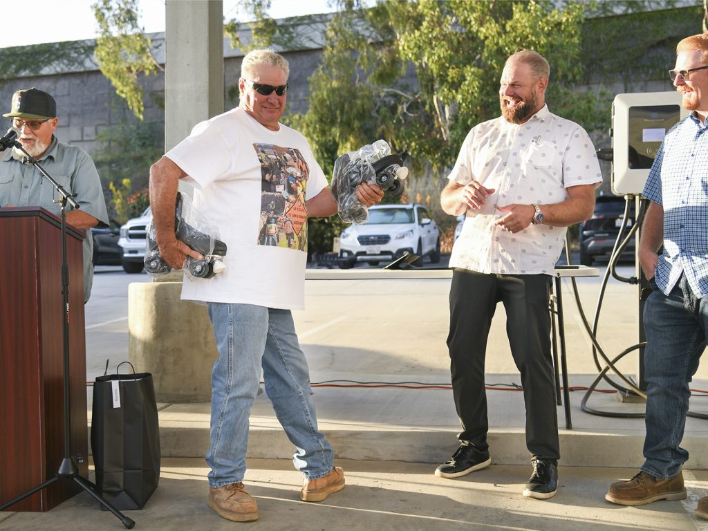 photo at Employee Years of Service event, Bob Ellis presented with a brand new pair of roller skates
